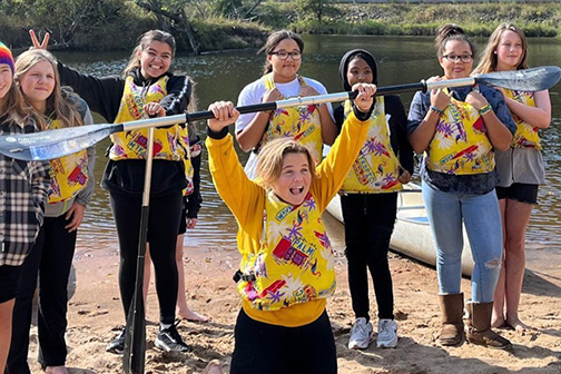 Teens celebrate a canoeing success