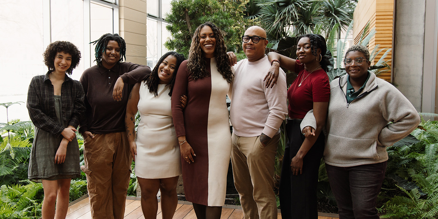 Staff shown posing for a picture