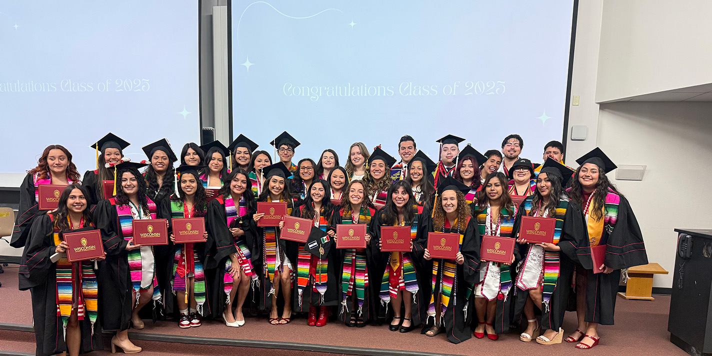 Graduating students shown posing for a picture