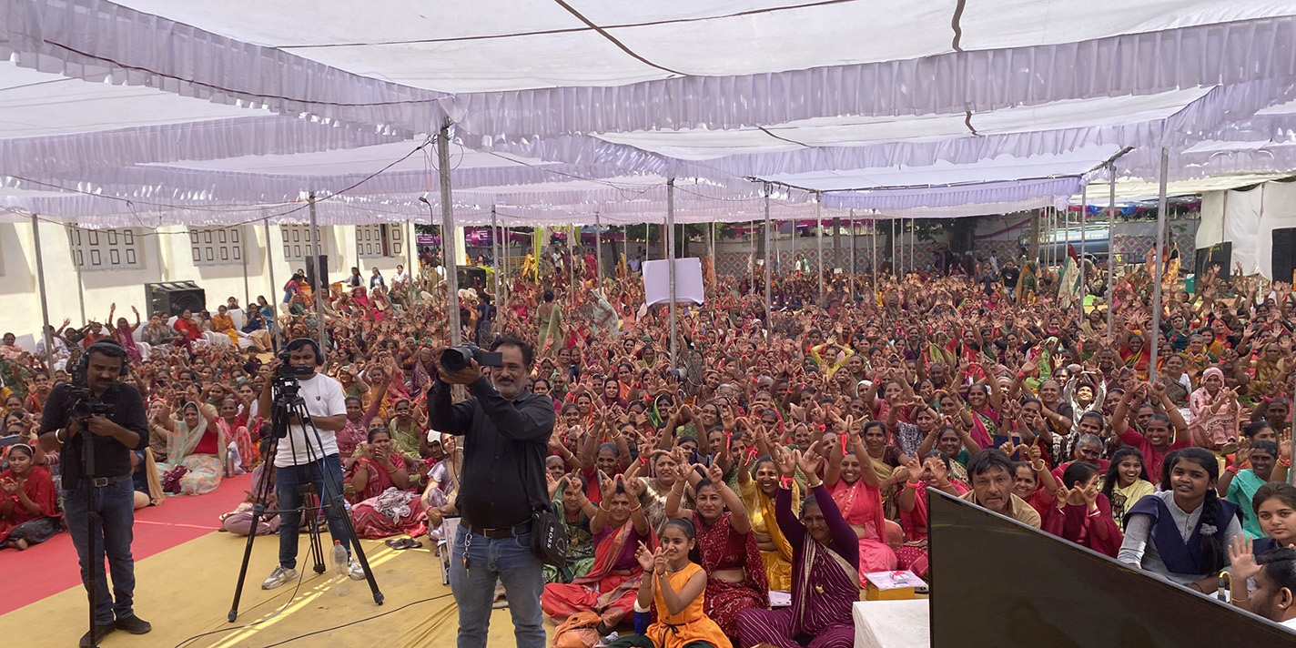 People shown gathered in a large space.