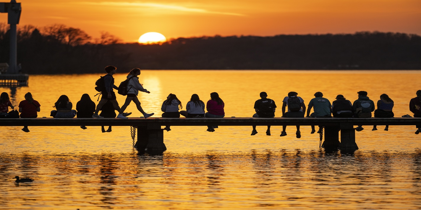 Coming out of winter hibernation, people line the Goodspeed Family Pier near the Below Alumni Center at the University of Wisconsin–Madison